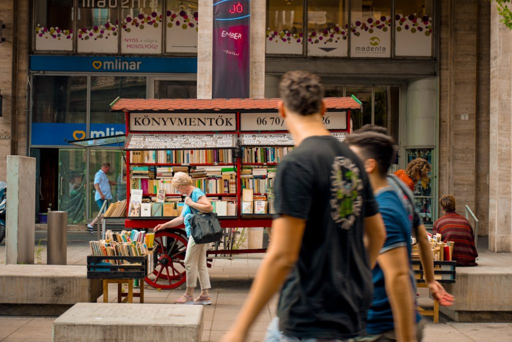a-group-of-people-walking-in-front-of-a-store-uei9do1y1mm
