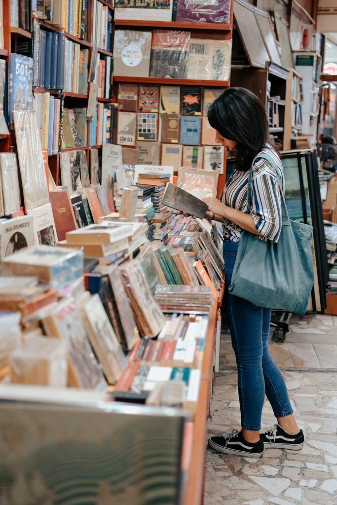 a-woman-looking-at-a-book-in-a-book-store-a5g2-oi530m